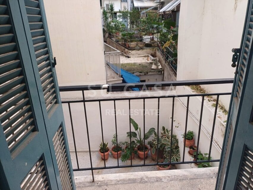 Εσωτερικό διαμέρισμα Su Casa με αποθηκευτικά ντουλάπια και ξύλινο πάτωμα.