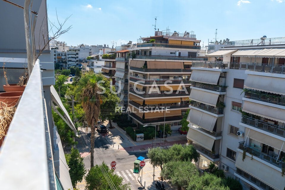 Πολυκατοικίες στην Αθήνα με πράσινο και δρόμους.