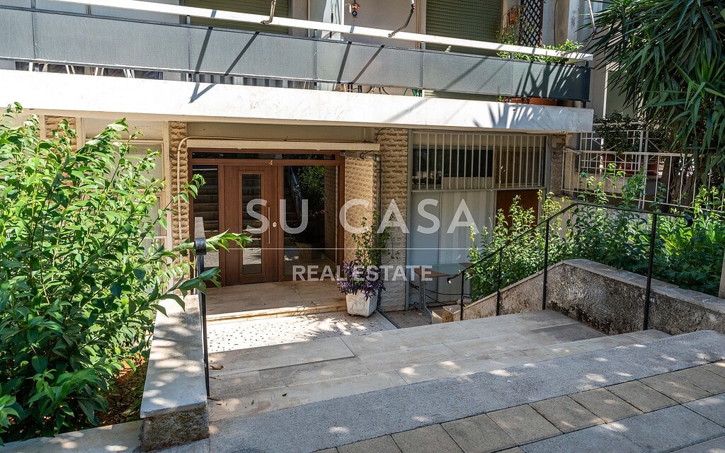 Είσοδος κατοικίας Su Casa με πράσινα φυτά και σκαλοπάτια.