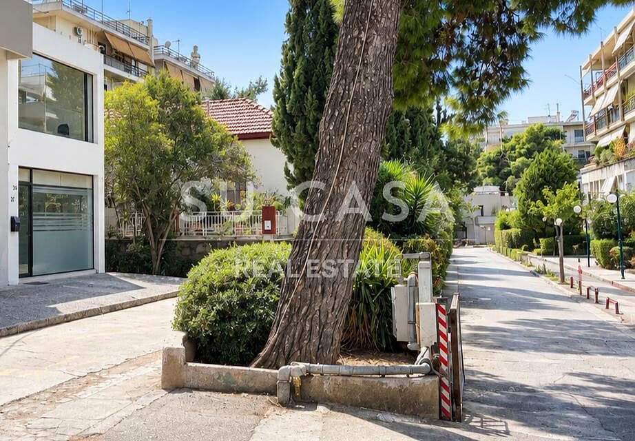 Πράσινο πάρκο με δέντρα και πεζόδρομο στην Αγία Παρασκευή.